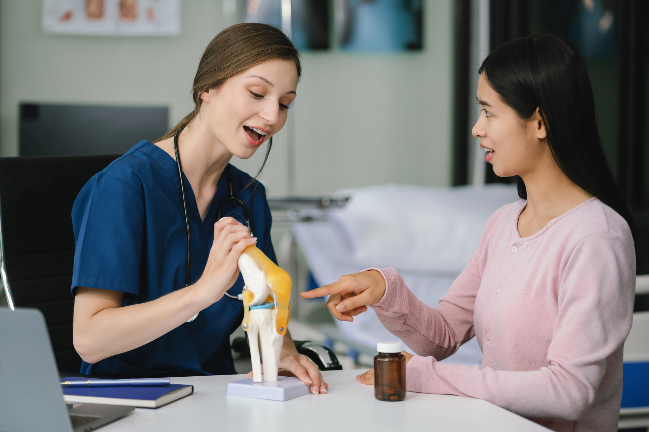 Female doctor and patient are talking and consulting at the table in a medical clinic or hospital health service.