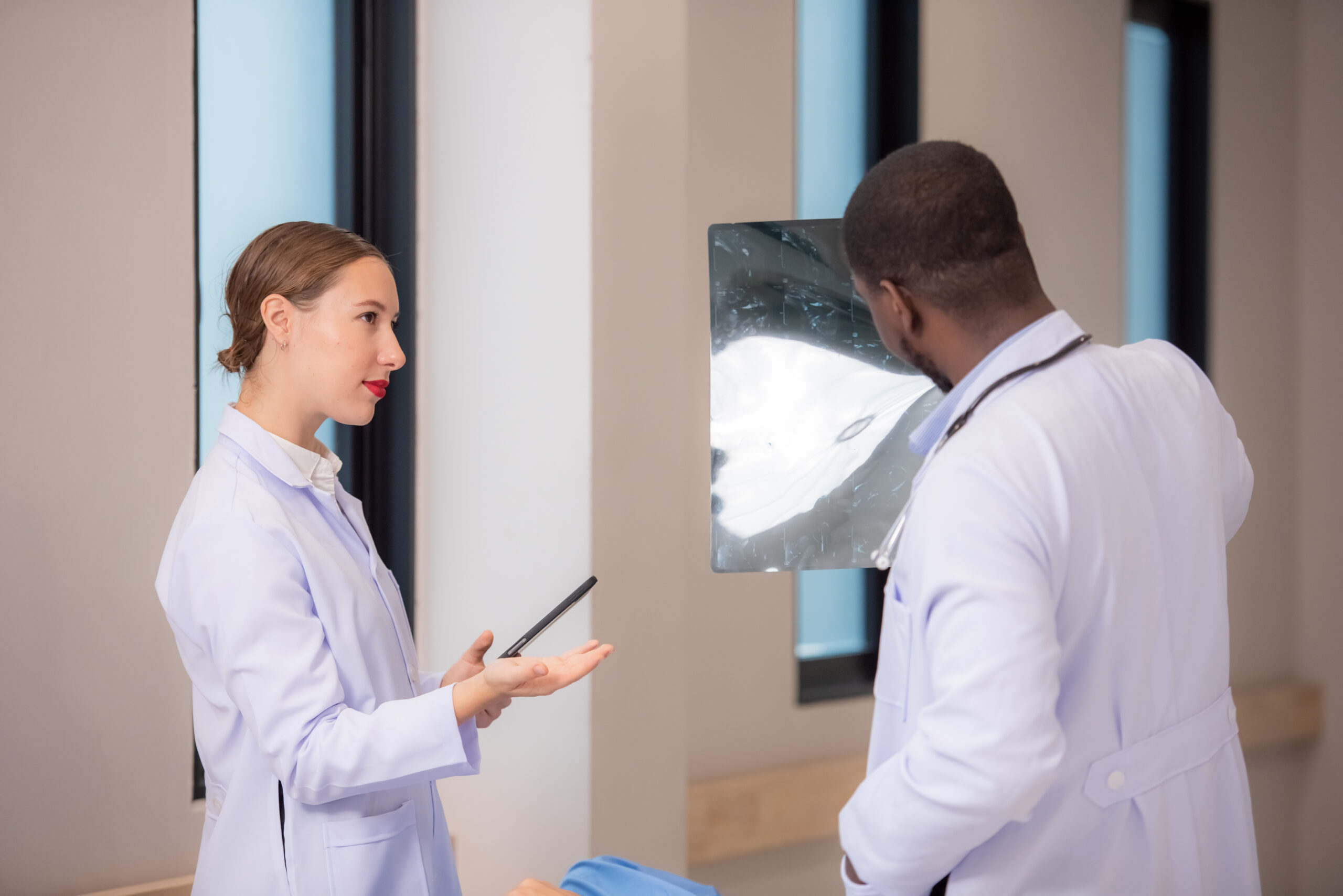 doctor examining x-ray in corridor of hospital