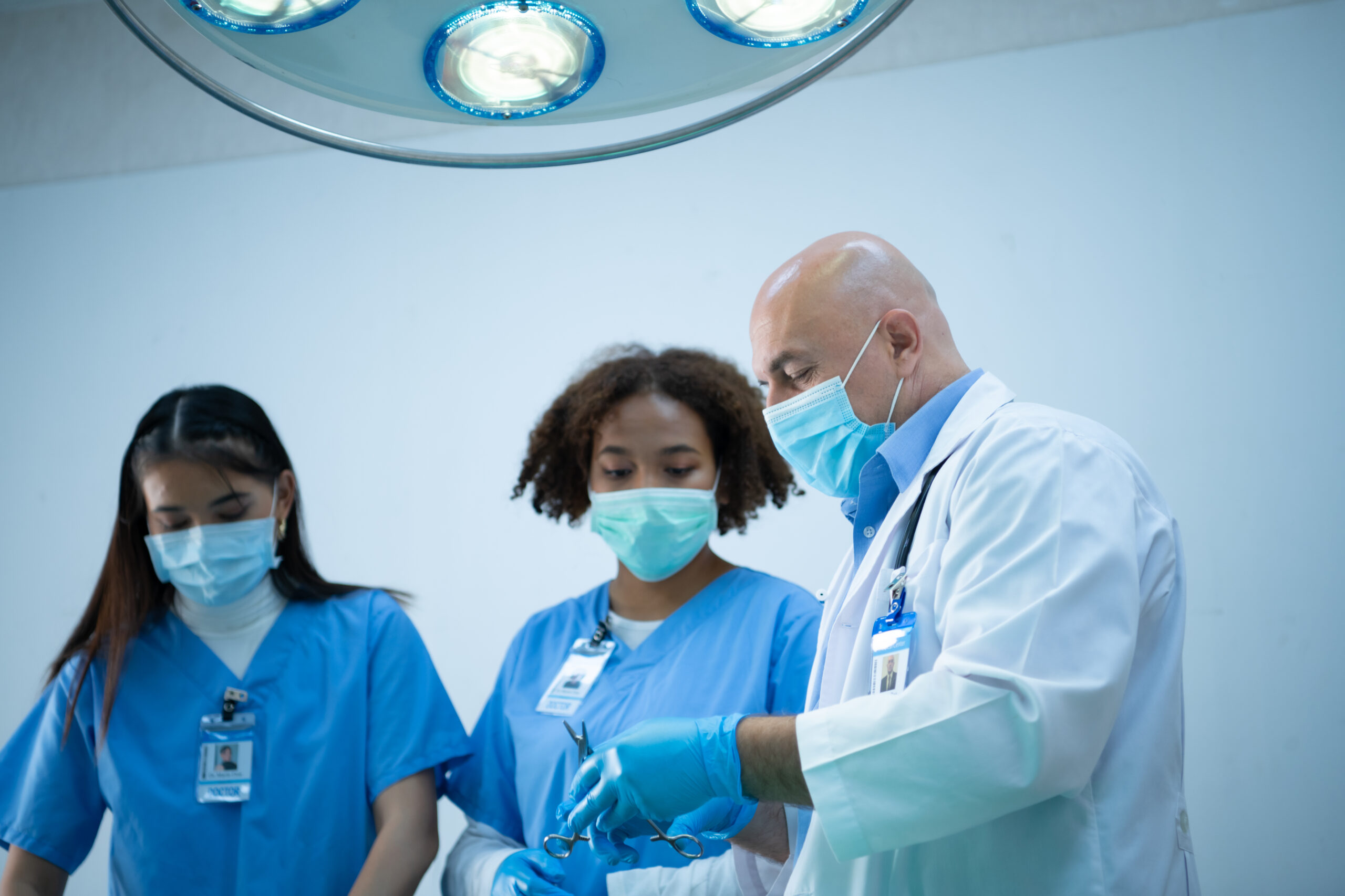 A medical professor is teaching surgery to medical students working at an international medical hospital.