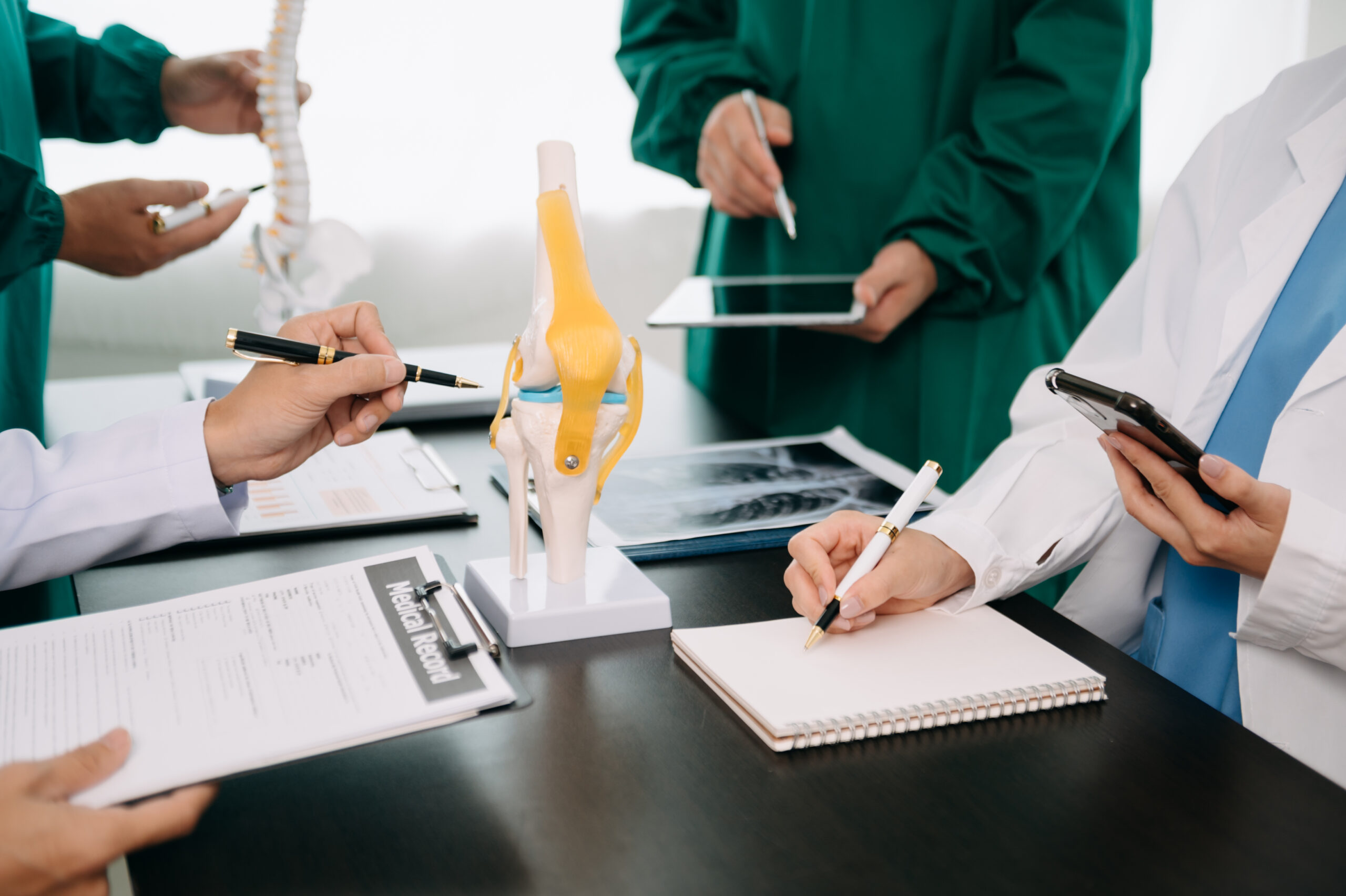 Medical technology network team meeting concept. Doctor hand working with smart phone modern digital tablet and laptop computer with graphics chart interface, with virtual icon diagram