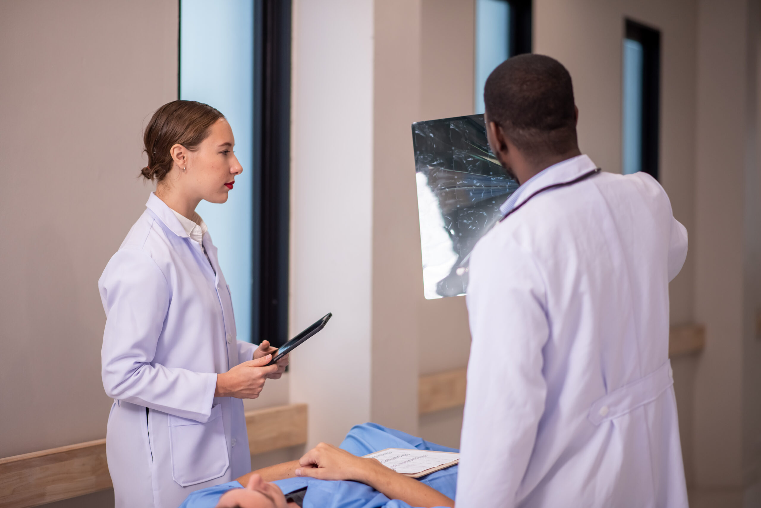doctor examining x-ray in corridor of hospital