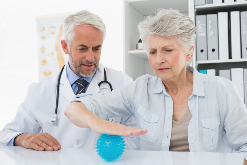 The current image has no alternative text. The file name is: male-doctor-with-senior-patient-using-stress-buster-ball-scaled.jpg