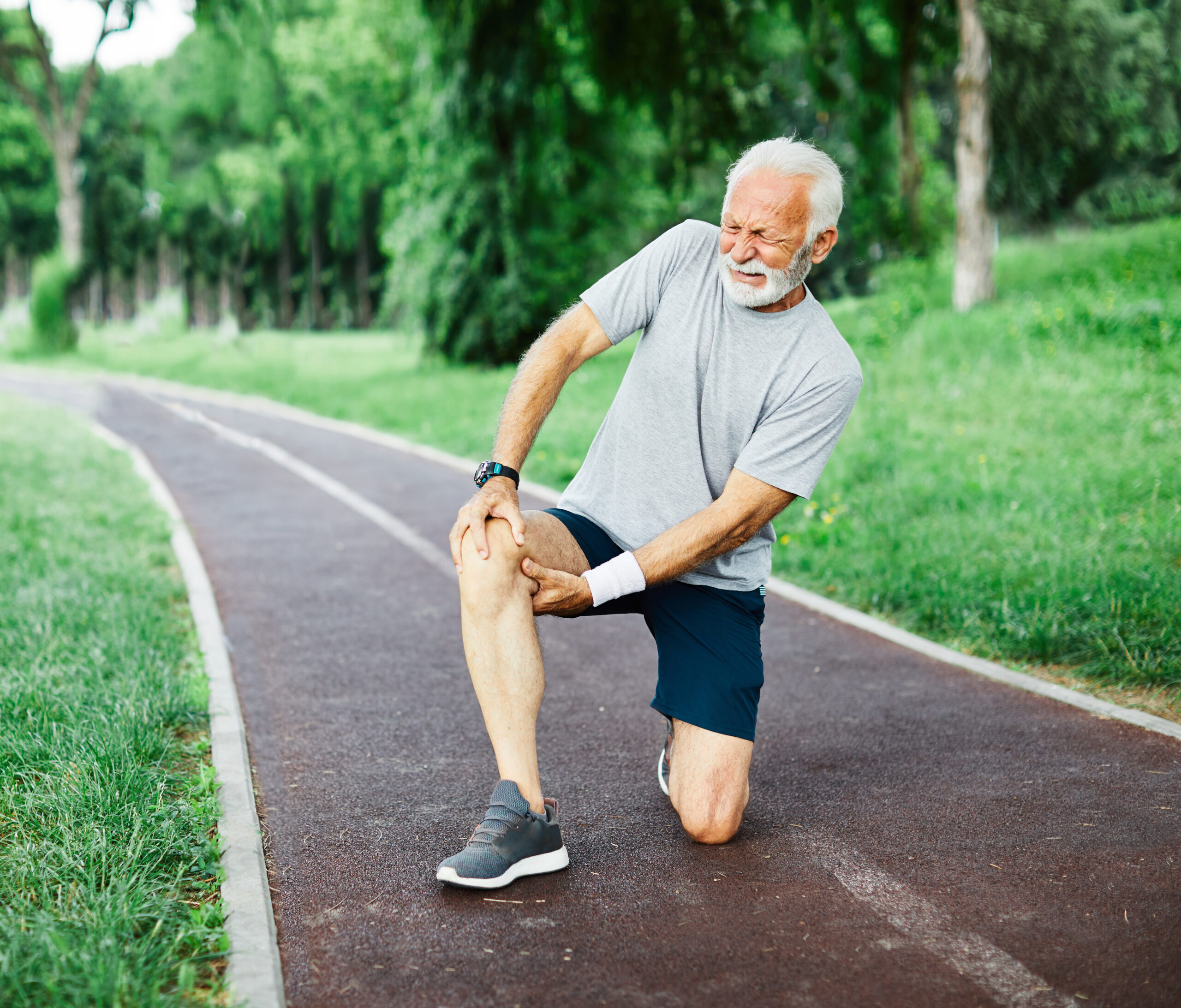 Active senior man  jogging has  injury problem  in the park